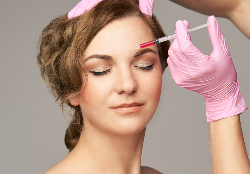 A Woman getting injection to her forehead | Get PRP Treatments at The Skin Clinic | Fargo, North Dakota